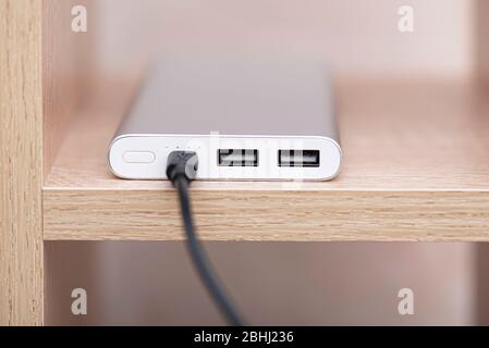 Close-up power bank with usb for charge, power bank for charging on wooden shelf Stock Photo