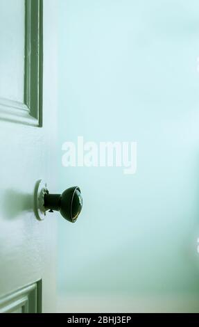 An open old vintage interior door and door knob with copy space Stock Photo