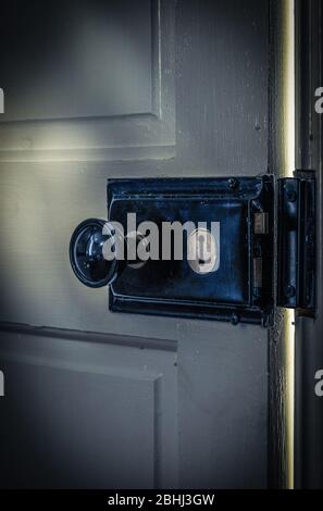 A vintage door ajar with light coming through the gap. Stock Photo