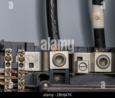 Wiring in electrical circuit breaker box panel with bus bar and copper wires. Concept of home maintenance, repair, remodeling Stock Photo