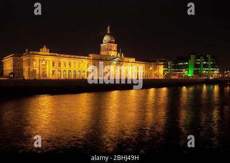 The Custom House at night in city of Dublin in Ireland, city landmark by the Liffey river, illuminated 18th century Neoclassical facade. Stock Photo