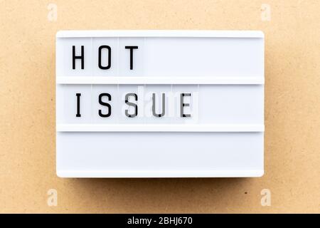 Light box with word hot issue on wood background Stock Photo