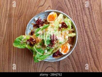 Caesar salad cooked in Asian way, shot from above Stock Photo