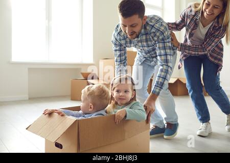 Happy family have fun playing in a new house in the room. Stock Photo