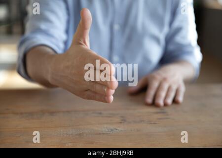 Close up confident businessman extending hand for handshake Stock Photo