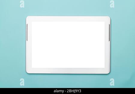 White tablet computer with blank screen mockup isolated on blue background. Clipping path. Stock Photo