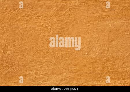 Colorful concrete wall, bright yellow vintage style of cement background paint with small texture details. Stock Photo
