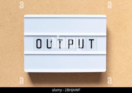 White lightbox with word output on wood background Stock Photo