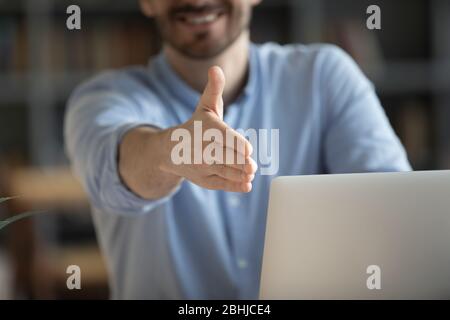Close up smiling friendly businessman extending hand for handshake Stock Photo
