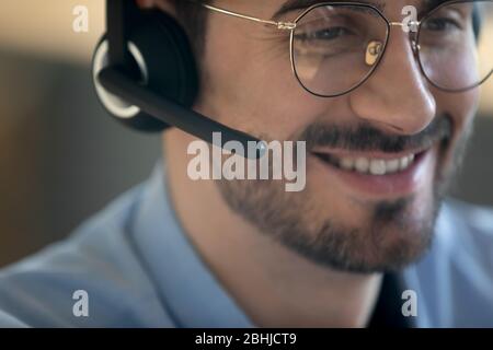 Close up smiling friendly man wearing headset with microphone Stock Photo