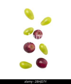 Falling green and red grapes isolated on white background with clipping path. Stock Photo