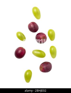 Falling green and red grapes isolated on white background with clipping path. Stock Photo
