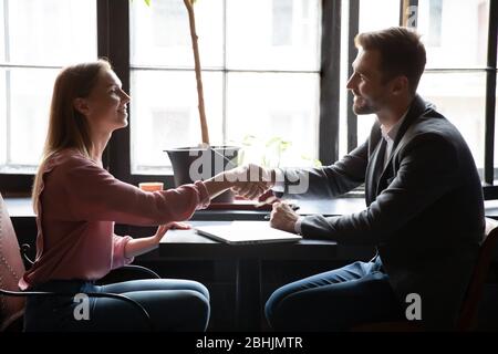 Smiling woman handshake get acquainted with male consultant Stock Photo