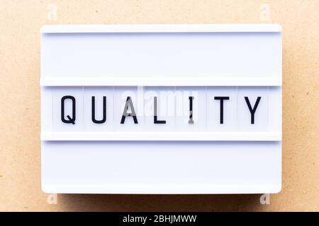 Lightbox with word quality on wood background Stock Photo