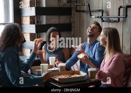 Happy diverse friends have fun eating out together Stock Photo