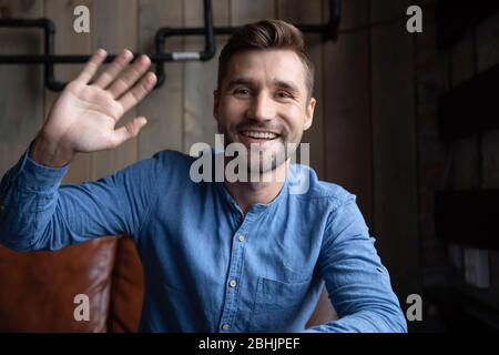 Headshot portrait of smiling man greeting talking on web Stock Photo