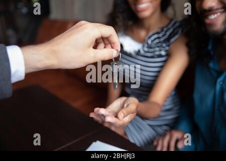 Realtor give keys to excited couple renters Stock Photo