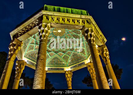 Mausoleum of poet Hafez at night with the moon at one side, Aramgah-e Hafez, Shiraz, Iran Stock Photo