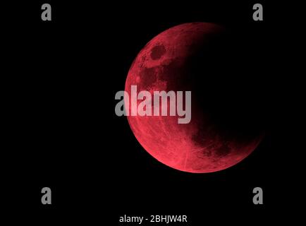 Half of red bloody moon in black space, moon with eclipse Stock Photo