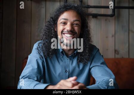 Headshot portrait of smiling biracial man having video call Stock Photo