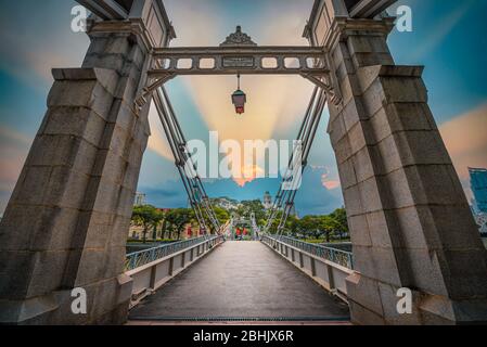 Cavenagh Bridge over singapore river at sunset in Singapore. Stock Photo