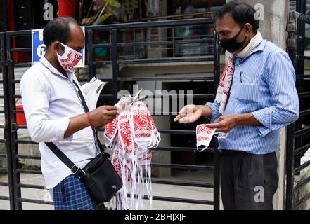 Guwahati, Assam, India. 26th Apr, 2020. A man selling Mask made from Assamese Traditional Gamosa on a street, during the nationwide lockdown to curb the spread of coronavirus, in Guwahati. Credit: David Talukdar/ZUMA Wire/Alamy Live News Stock Photo