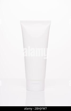Mockup body treatment advertisement concept. Full length size vertical photo of plastic tube with empty place for label facial cream for woman isolate
