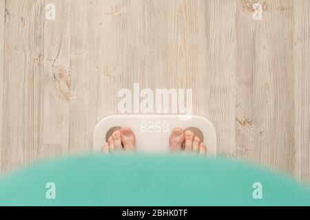 Female foot takes a step on smart scales that makes bioelectric impedance  analysis, BIA, measurements of body fat Stock Photo - Alamy