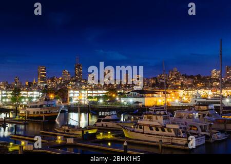 Beautiful scenic view on night San Francisco and Marine terminal bay cruise and ferries from Pier 39, Bay area, California state, USA Stock Photo
