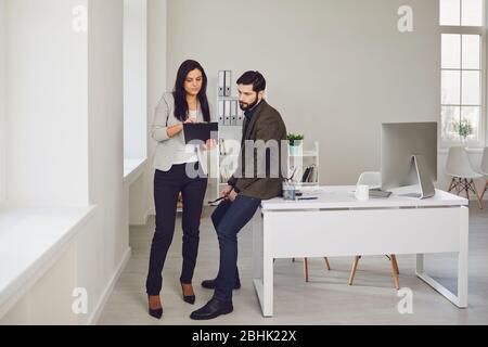 Business people talking in a white office. Stock Photo