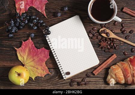 Composition with notepad, coffee and different fruits on dark wooden table, top view Stock Photo