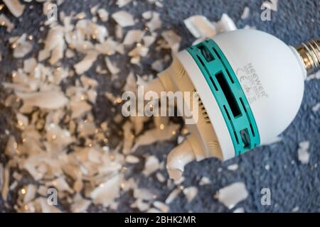 A shattered video studio light - compact fluorescent lamp or CFL bulb - which has released mercury vapour Stock Photo