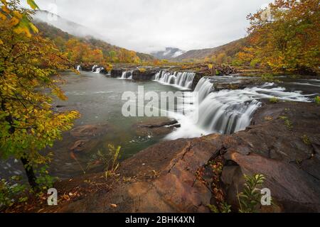 A foggy morning view at Sandstone Falls in autumn on the New River in West Virginia. Stock Photo