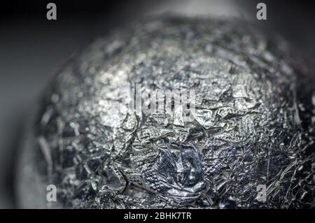 Unusual abstract techno view of crumpled aluminum foil ball, close-up, macro photography Stock Photo