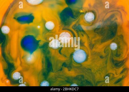 Colorful texture of mixed colors. Waves of orange and blue with oily white bubbles. Abstract natural background Stock Photo