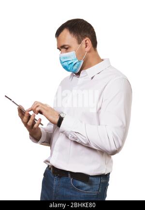 Man in a medical mask with a digital tablet in hands Isolated on a white background. Quarantine concept Stock Photo