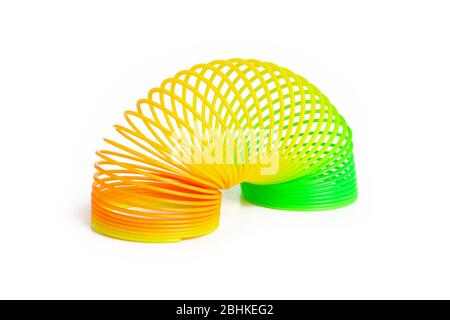 Toy plastic colorful rainbow spiral for play isolated on white Stock Photo