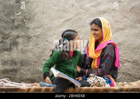 happy indian mother and daughter, mother helping her daughter in study Stock Photo