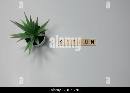 The word Action written in wooden letter tiles on a white background.  Concept take action in business. Stock Photo