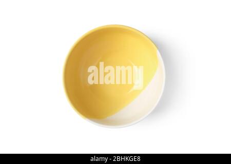 Closeup yellow ceramic cup isolated on white. View from above Stock Photo