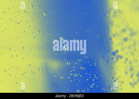 Blue yellow color blurred background with water drops Stock Photo