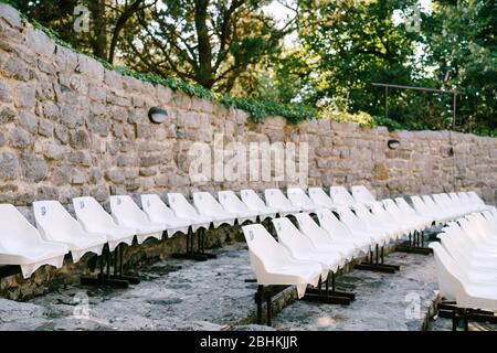 White plastic chairs in the amphitheatre in the old town of Bar, in Montenegro. Stock Photo