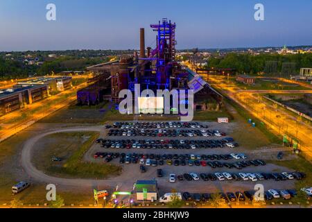 Dortmund, Deutschland. 27th Apr, 2020. firo: 26.04.2020, Germany, NRW, Dortmund, industrial culture, Ruhr area, cinema in Corona times, drive-in cinema in Dortmund against the backdrop of a typical Ruhr area, in front of the old blast furnace on Phoenix-West, highlight, drone photo, drone | usage worldwide Credit: dpa/Alamy Live News Stock Photo