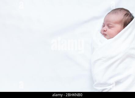 infancy, childhood, family, care, medicine, sleep, health concept - banner portrait of newborn baby wrapped in diaper on white background, copy spase Stock Photo