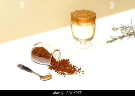 Iced dalgona coffee, fashionable fluffy creamy whipped coffee on a trendy coloured background. Stock Photo