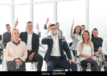 group of employees asking questions during a business meeting Stock Photo