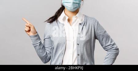 Covid19, virus, health and medicine concept. Portrait of young serious-looking asian girl in medical mask, prevent spreading coronavirus and influenza Stock Photo