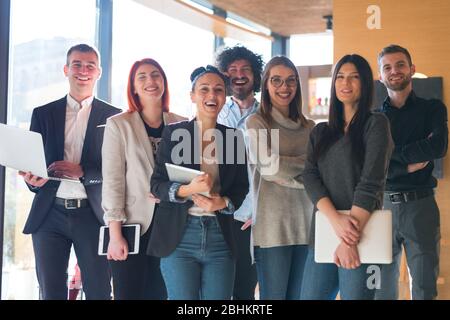 Portrait of successful creative business team looking at camera and smiling. Diverse business people standing together at startup. Stock Photo