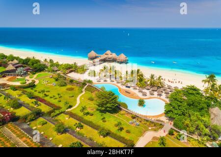 Aerial view of beautiful hotel on the sea. Sandy beach