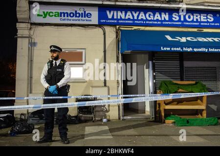 Police attend the scene in Aldborough Road North, Ilford, east London where a baby girl and a boy aged three have been stabbed to death while a 40-year-old man was found injured and was taken to hospital. Stock Photo